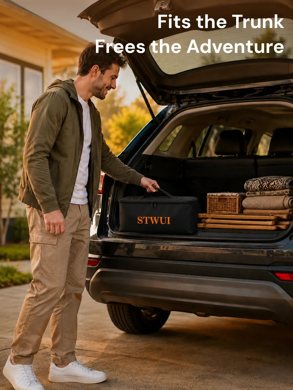 Man packing the STWUI projector screen carry bag into a car trunk for easy travel
